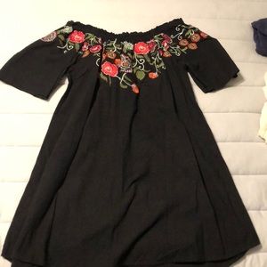 Black dress with floral design. Off the shoulder
